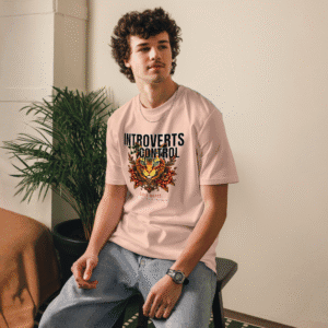 Model wearing the “Introverts Control” t-shirt in peach color – featuring a tiger with floral accents and the quote “Still quiet. Still the main character.” by AmizDesign.