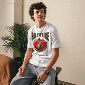 Model wearing white organic cotton t-shirt with PALESTINE watermelon protest design – unisex fit by AmizDesign